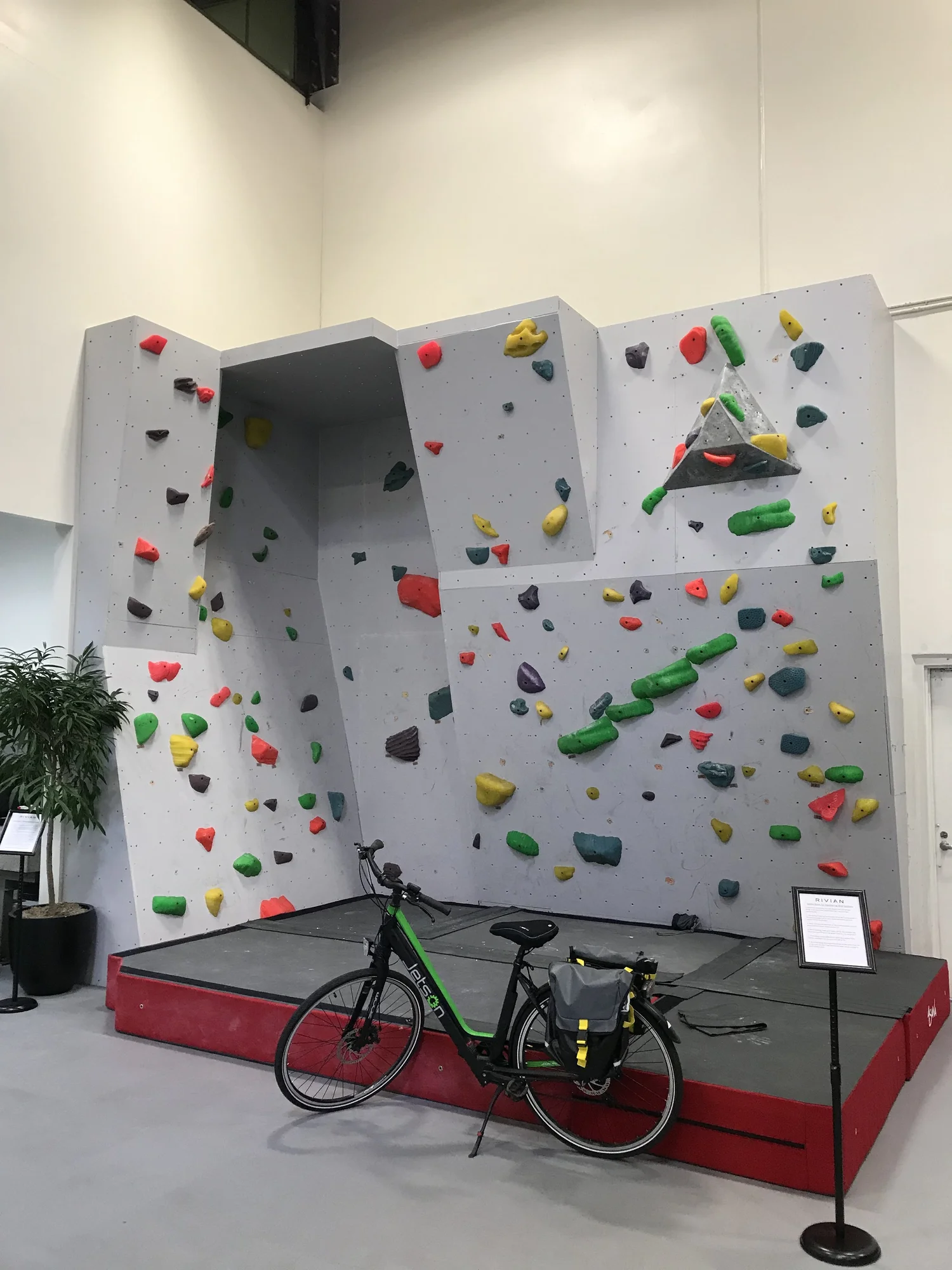 Rivian branded facility design featuring a custom indoor climbing wall
