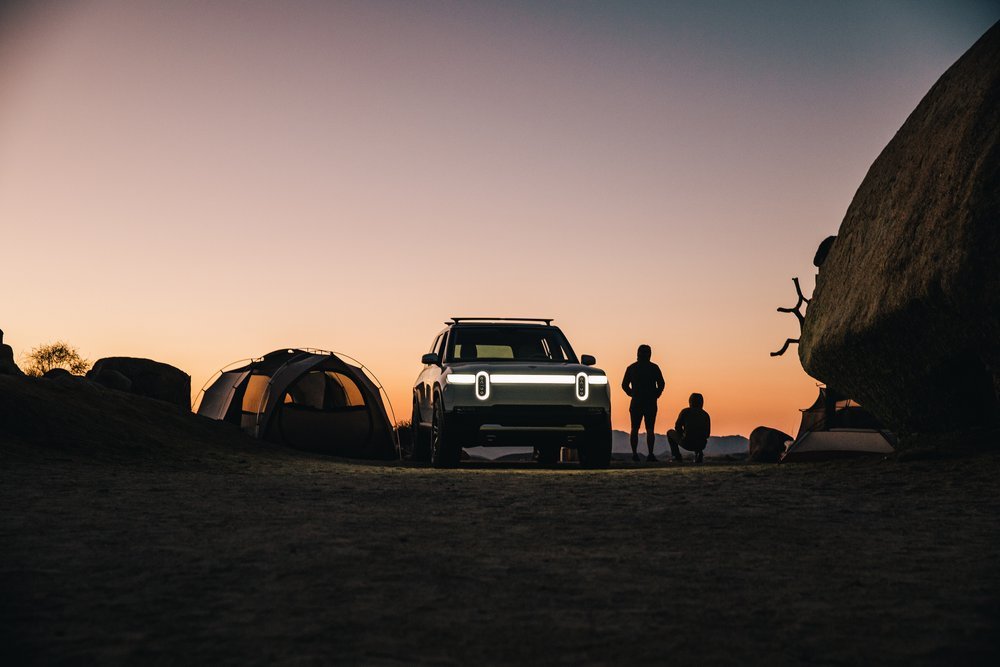 Rivian R1S at a desert campsite at sunset during the customer content shoot